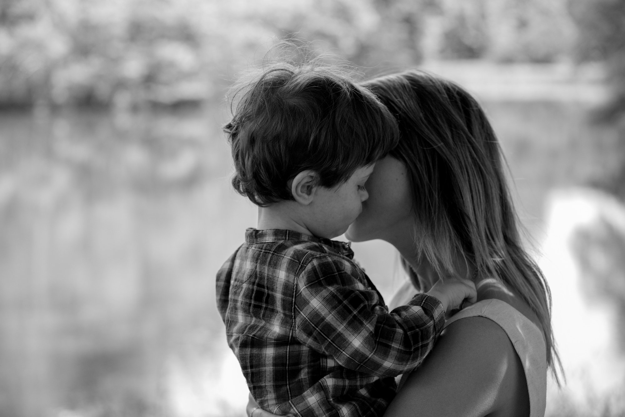 Mother Carrying Son Outdoors